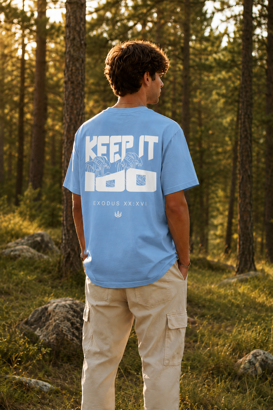 Person wearing a blue t-shirt with text in a forest
