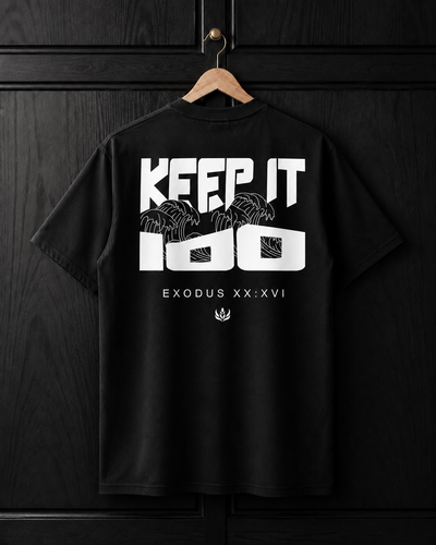 Black t-shirt with white text and graphics on a wooden hanger against a dark wooden background
