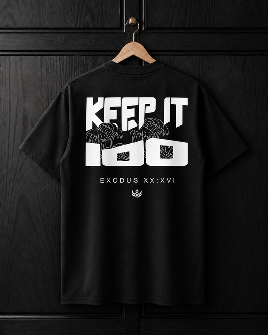 Black t-shirt with white text and graphics on a wooden hanger against a dark wooden background