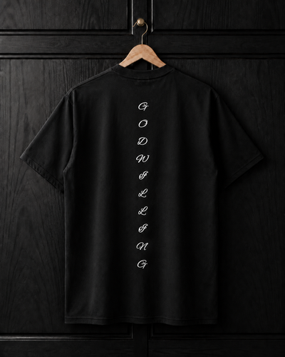 Black t-shirt with white text on a wooden hanger against a dark wooden panel background